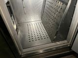 a stainless steel door that is open in a room