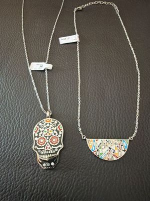 a couple of necklaces that are sitting on top of a table