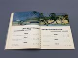 an open book with a picture of a beach scene on it