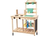 a wooden workbench with a green bucket and tools on it