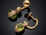 a pair of gold earrings with green stones and diamonds