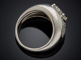 a close up of a silver ring with diamonds on a black surface