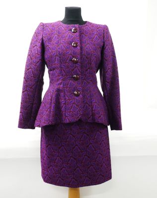 a close up of a purple dress and jacket on a mannequin