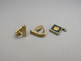 a pair of gold earrings with a blue enamel and a gold plate