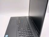 a laptop computer sitting on a table with a keyboard