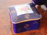 a small purple box sitting on top of a wooden table