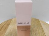 a bottle of dessance body lotion on a wooden table