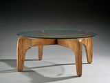 a glass table with wooden legs and a glass top