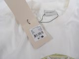 white t - shirt with yellow stripes and a tag on it