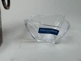 a glass bowl with a label on it next to a coffee pot