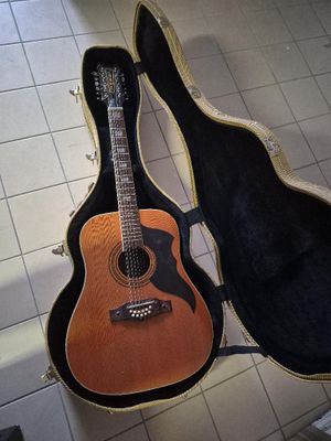 a guitar in a case on the floor next to a guitar case