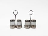 three glass salt and pepper shakers on a white surface
