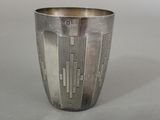 a silver cup that is sitting on a table