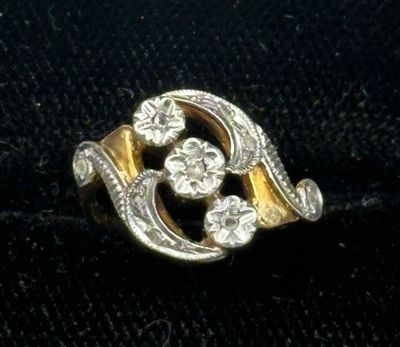 an image of a gold and diamond ring on a black cloth