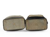 a pair of brown and black luggage bags on a white background