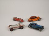 several toy cars are lined up on a white surface