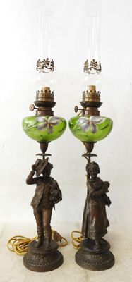 pair of antique bronze and green glass lamps with figures on them