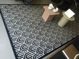 a black and white rug on the floor in a room