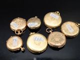 six gold lockes with the names of five different people on them