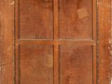 an old wooden door with four panes of glass on top of it