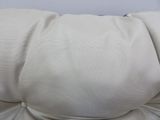 a close up of a pillow on a white couch