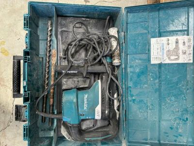 a blue box with tools inside of it on the floor
