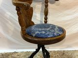 an image of a wooden chair with a blue cushion on it