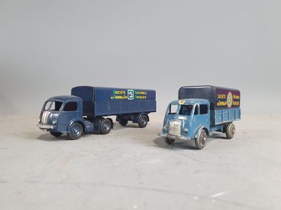 two toy trucks sitting next to each other on a table