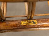 a close up of a bamboo chair with a label on it