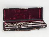 a flute in a case on a white surface