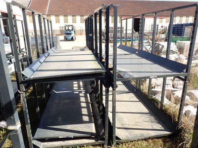 many metal shelves that are on the side of a building