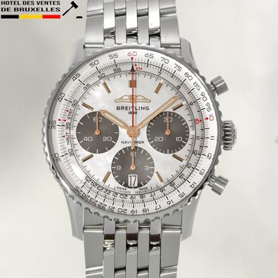 a close up of a watch with a stainless steel bracelet