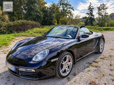 a picture of a black sports car parked in a parking lot