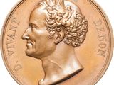 une image d'une pièce d'or avec le profil d'un homme
