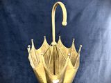a gold umbrella with a crown on top of it