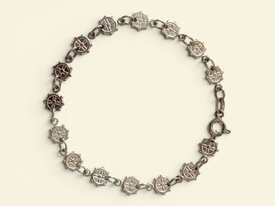 an image of a silver bracelet with flowers on a white background