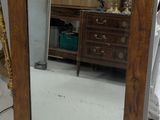 a mirror that is sitting on the floor in a room