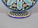 a blue and black plate with a flower design on it
