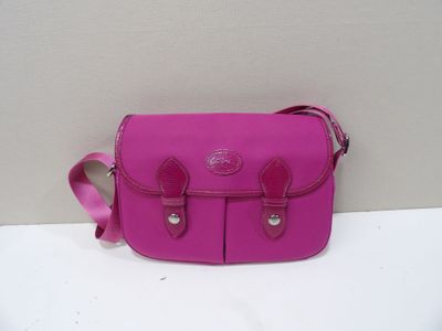 a close up of a pink purse on a white surface