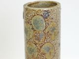 a vase that has a green and yellow design on it