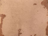 a brown piece of paper with a white sticker on it
