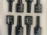 nine bottles of nail polish on a white surface