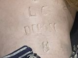 a small tattoo on the back of a woman ' s neck