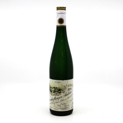 a bottle of wine sitting on top of a white table