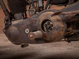 a close up of an old motorcycle with a rusted engine