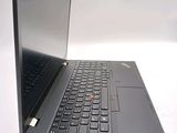 a laptop computer sitting on a table with a keyboard
