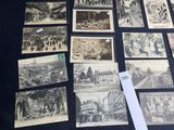 a lot of old black and white pictures on the table