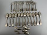 a lot of silver spoons and forks on the table