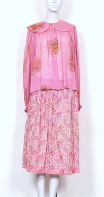 pink dress with floral pattern and collared neckline on mannequin base