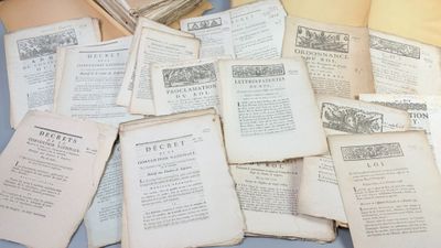 a pile of old books sitting on a table